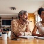 A couple focused on retirement planning at home at a table