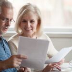 An older couple looking through their investment wealth management strategy together at home