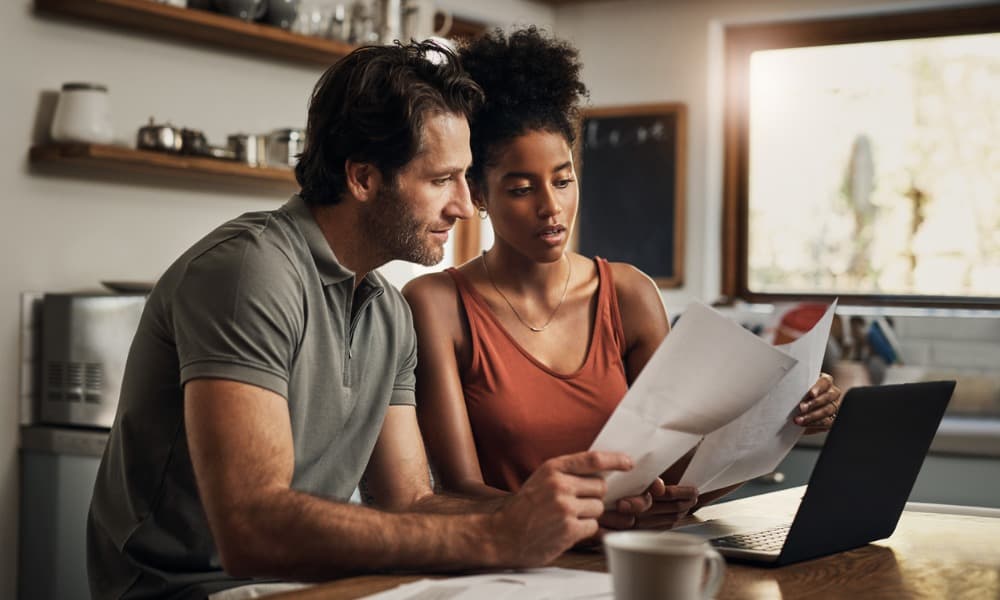A couple going over insurance coverage options together at home