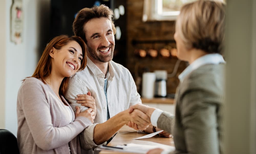 A couple meeting with a financial advisor to discuss the implementation of a trust into their financial planning.