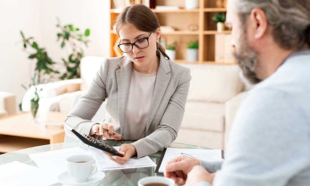 A business owner meeting with an advisor about improving cash flow management.