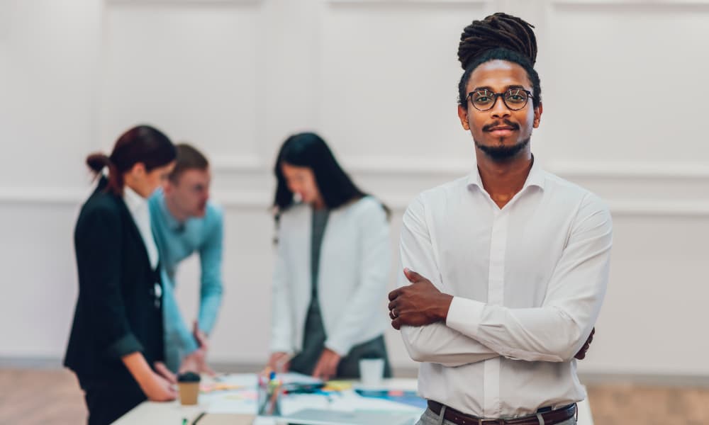 A business owner working with his financial advisors to create essential wealth management strategies for entrepreneurs.