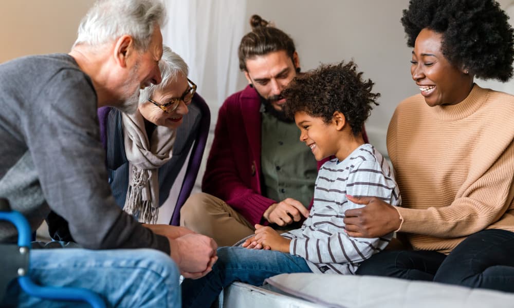 ee generations of a family meeting about education funding goals in a living room.