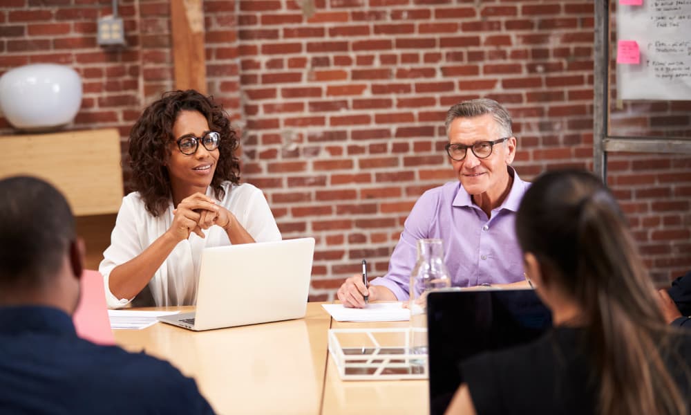 Business owners meeting in a conference room to discuss succession planning