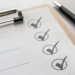 Close-up of a checklist with marked boxes and pen, symbolizing a year-end retirement checklist planning