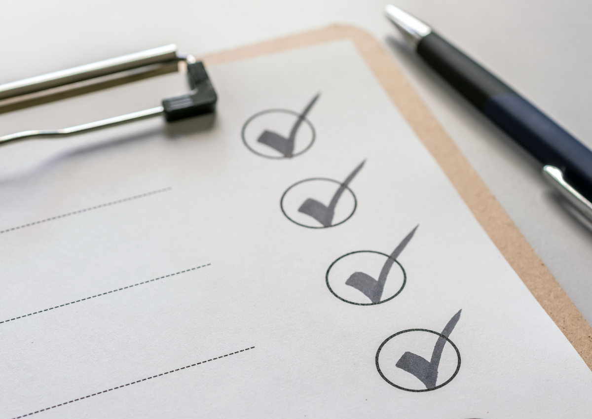 Close-up of a checklist with marked boxes and pen, symbolizing a year-end retirement checklist planning