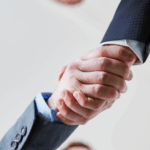 Close-up of two business professionals shaking hands, symbolizing partnership, trust, and successful business agreements.