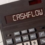 Calculator displaying “cash flow” highlighting financial mistakes high earners make with income management