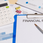 Lifetime Gifting Financial plan document on a clipboard with calculator and business charts on a desk
