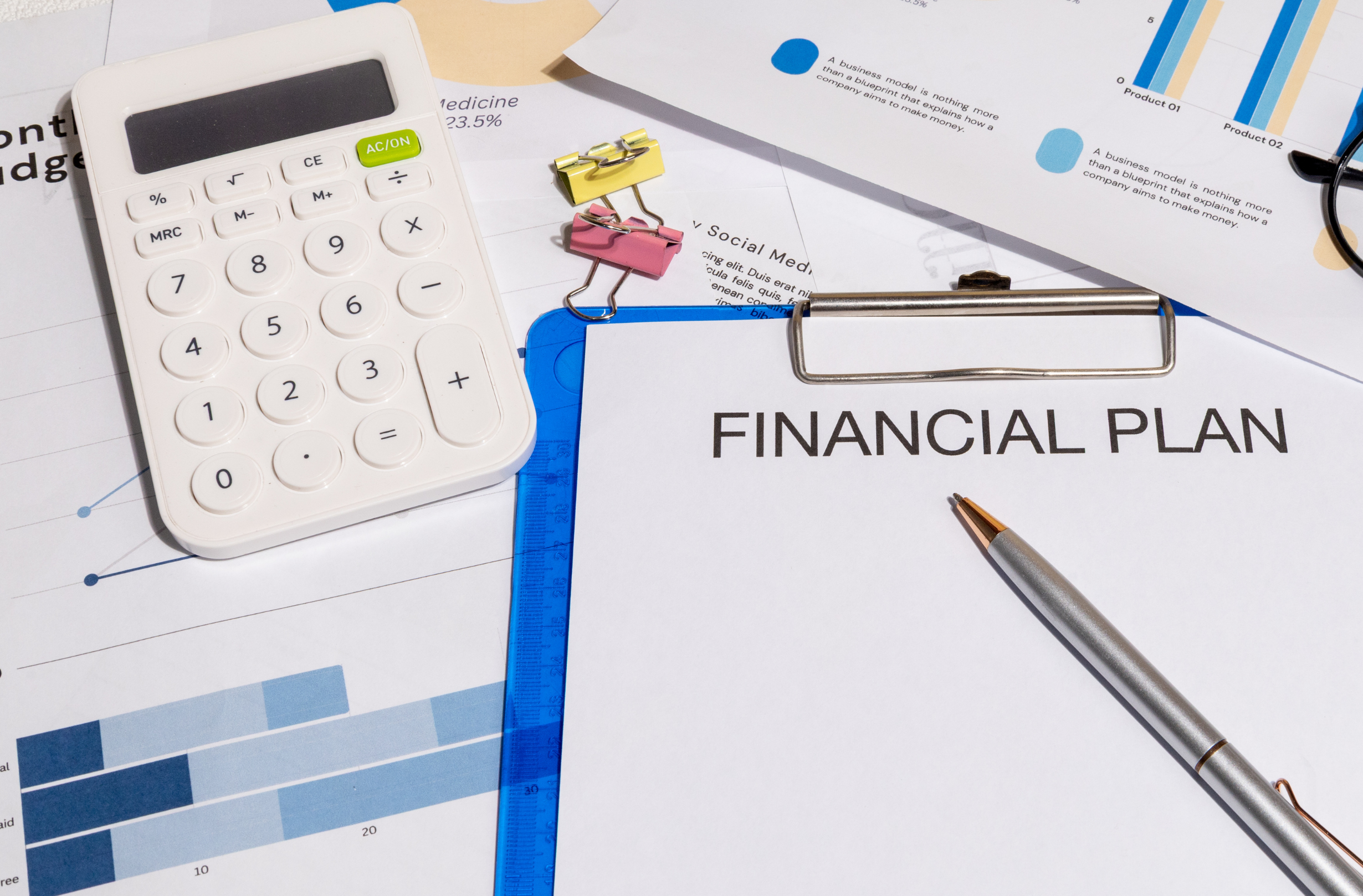 Lifetime Gifting Financial plan document on a clipboard with calculator and business charts on a desk