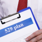 529 plans document on clipboard held by financial professional for education and wealth planning