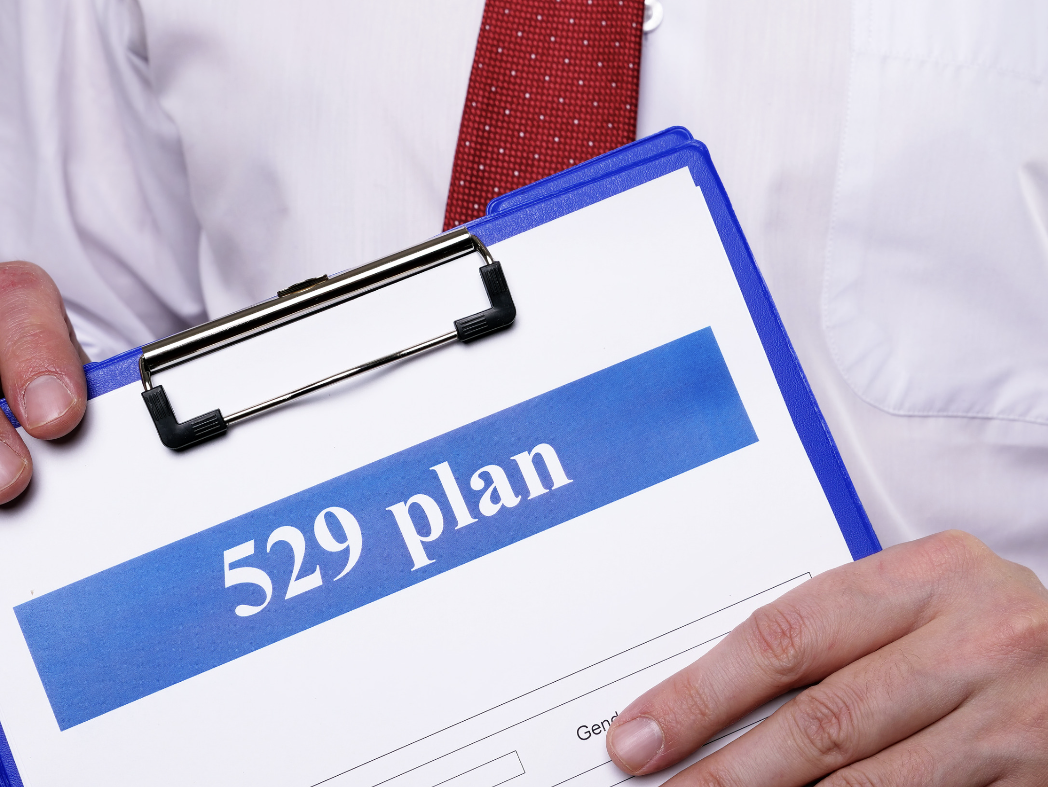 529 plans document on clipboard held by financial professional for education and wealth planning