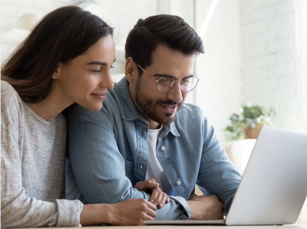 young couple checking a laptop