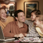 Family reviewing retirement income together with laptop and printed documents