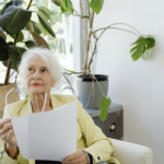 elder woman holding a document