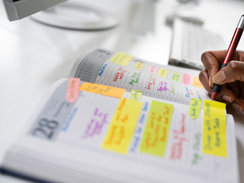 planning in a notebook with sticky pads