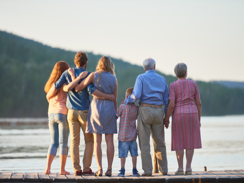 a photo of a family facing the sea