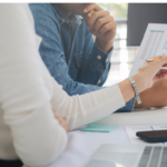 two persons planning with a paper and graph